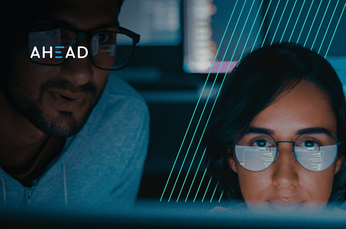 A man and a woman looking at a computer screen